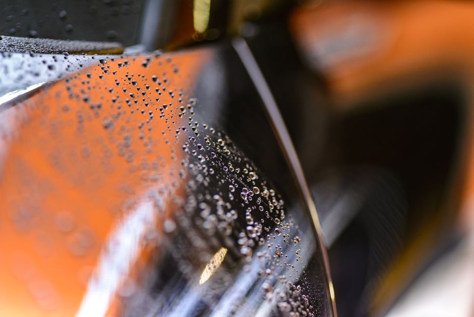 Water beading perfectly on a car hood treated with ceramic coating