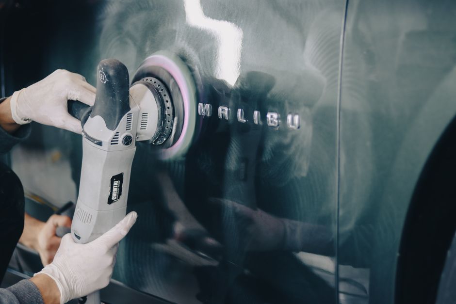 Using a professional machine polisher to correct car paint imperfections